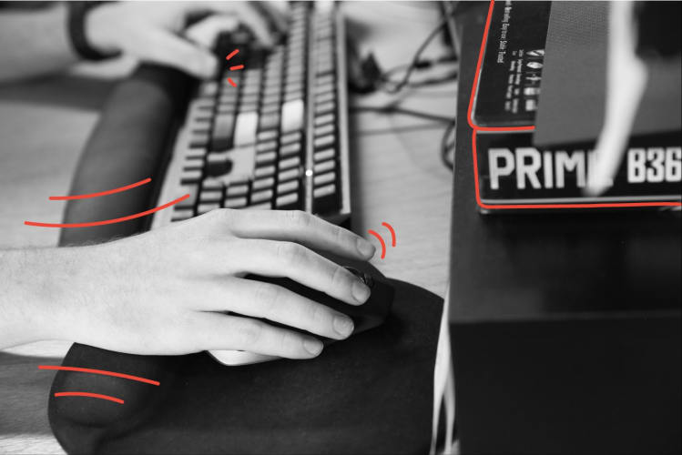 A close up photo of someones hands using a keyboard and mouse