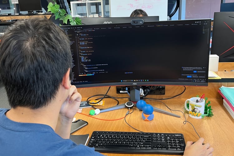A photo of a man working on a computer