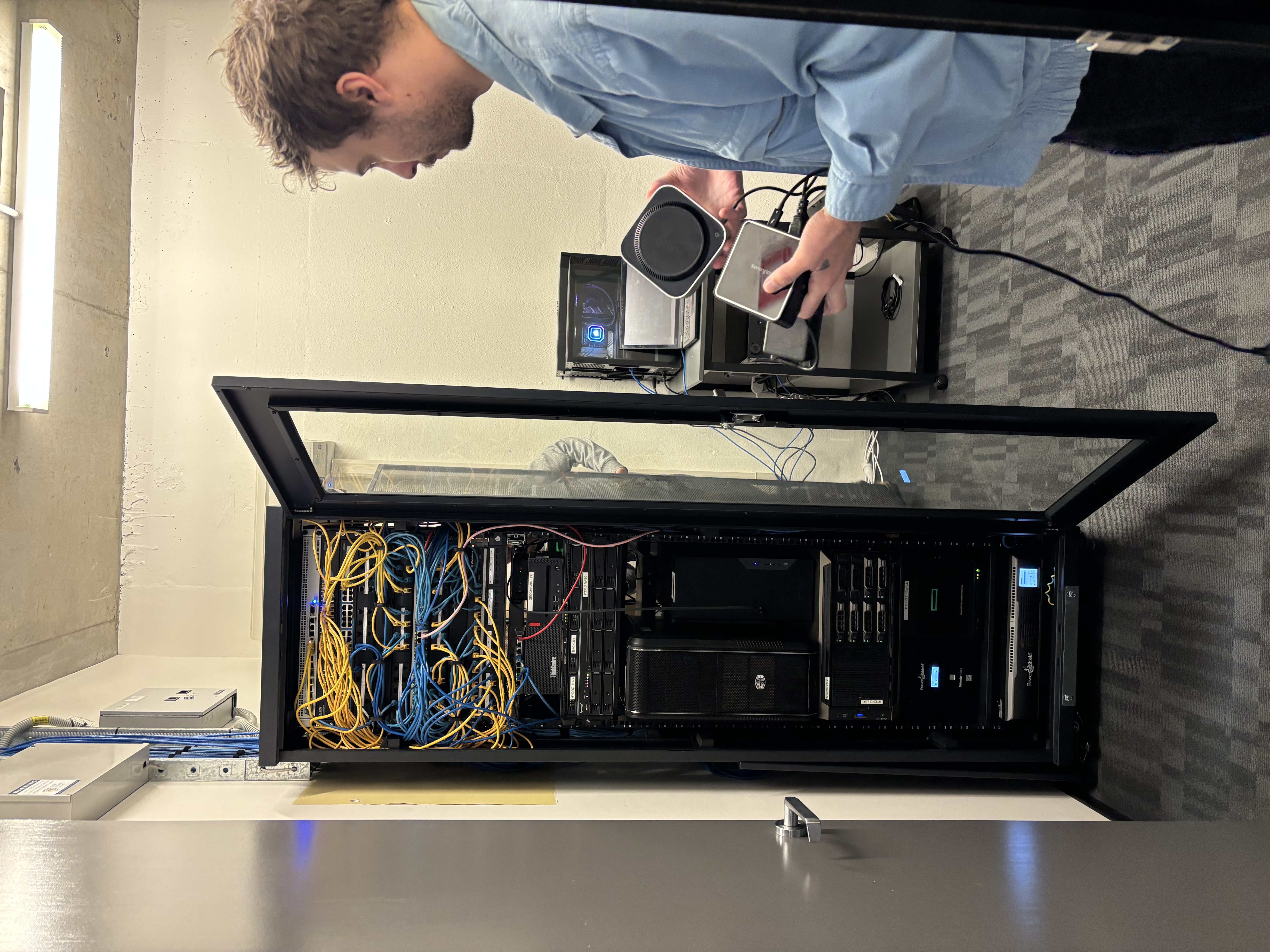 Aiden standing infront of the Hydrobiology server. ,Holding a mac mini