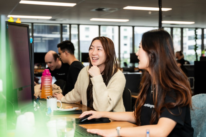 Photo of two women working on computers