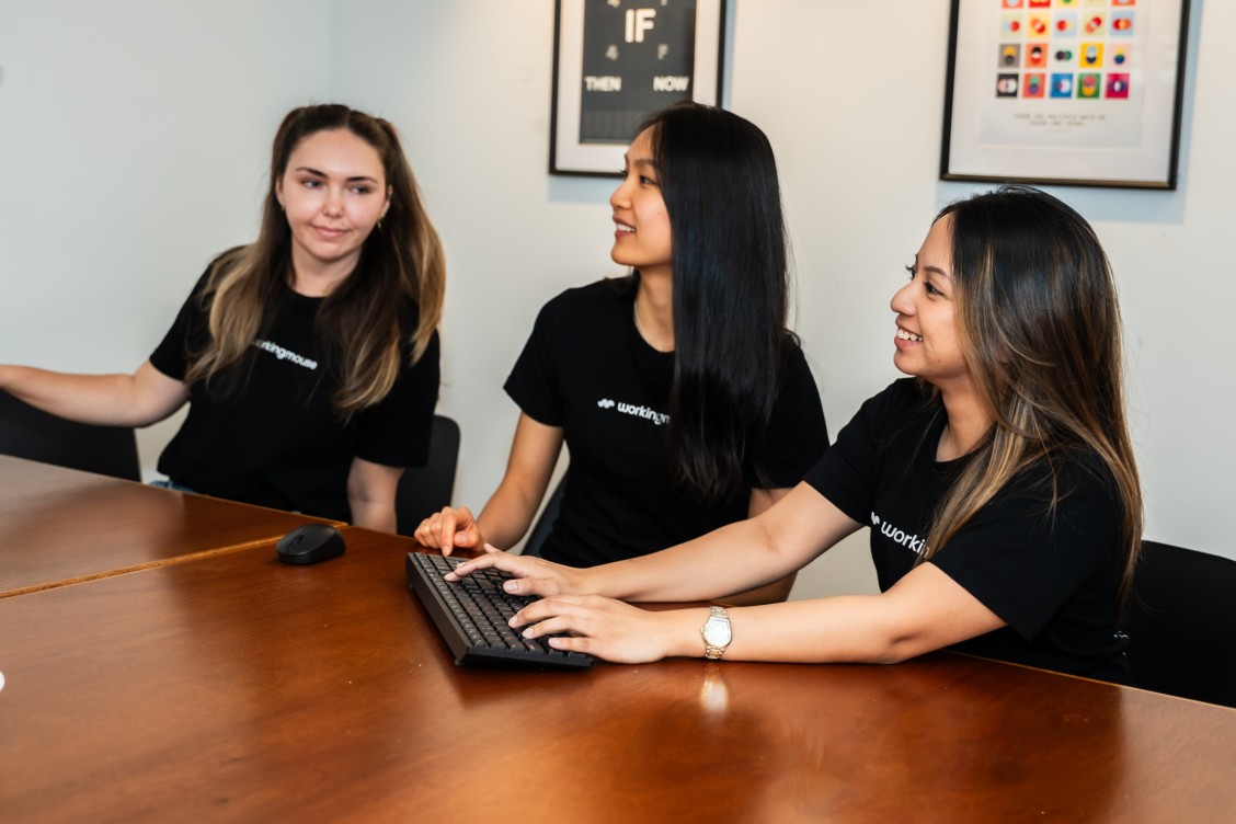 Three women working at a desk