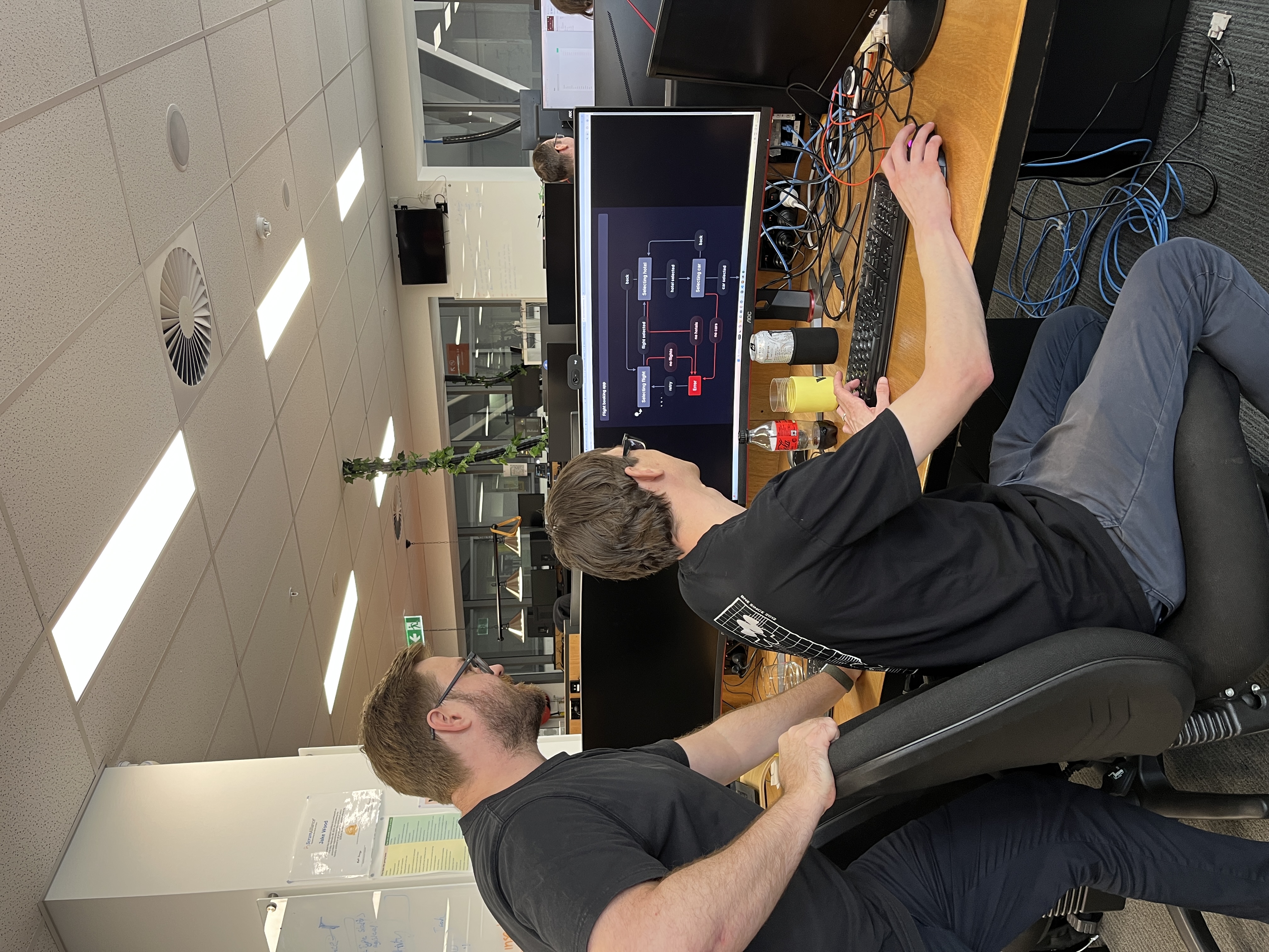 Two WM employees working on a computer