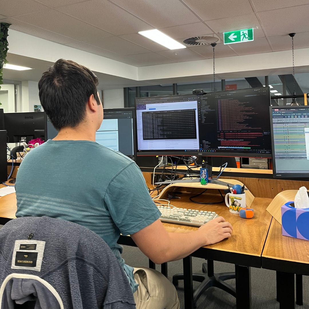 A photo of a man working at a computer