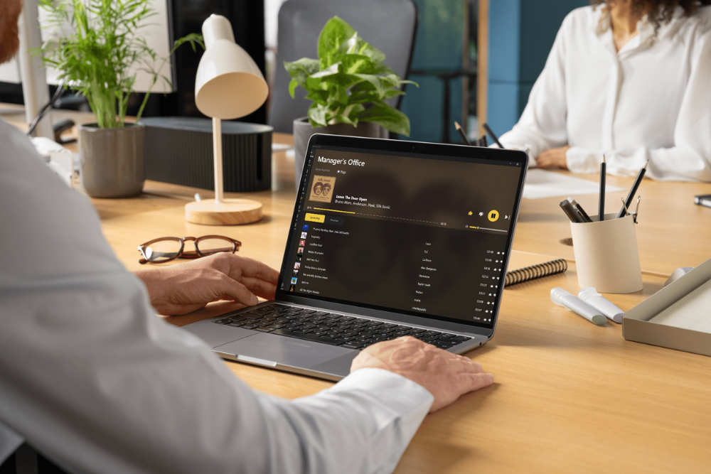 A photo of a laptop with the Mustard Music app open on the screen