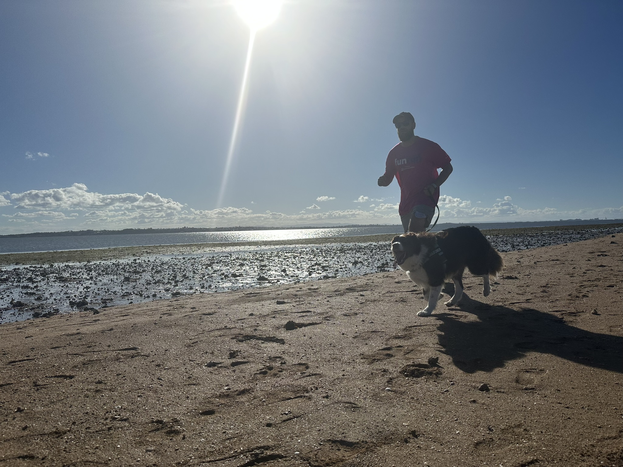 A photo of a workingMouse team member running iwth his dog at the walk
